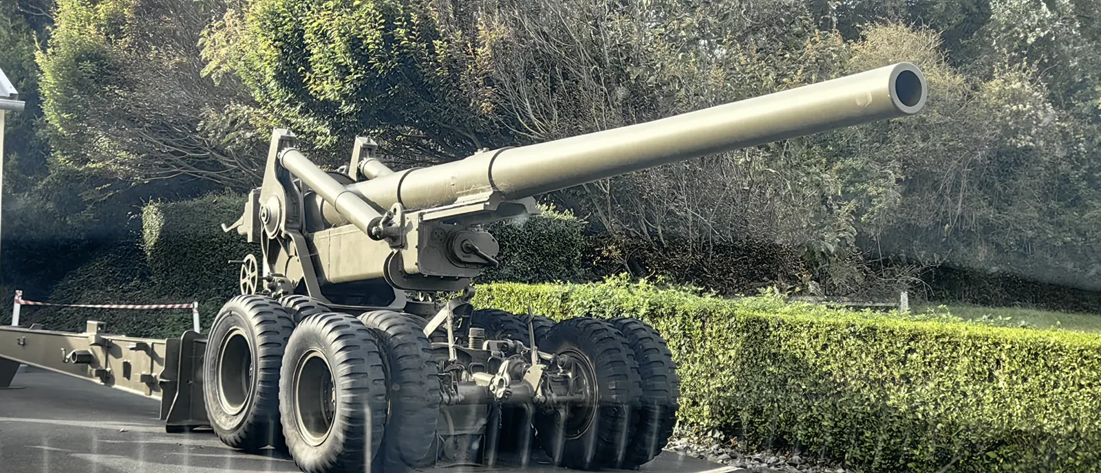 American 155 mm M1 Long Tom field gun on its wheeled carriage, seen through the car window on the D-Day coast of Normandy