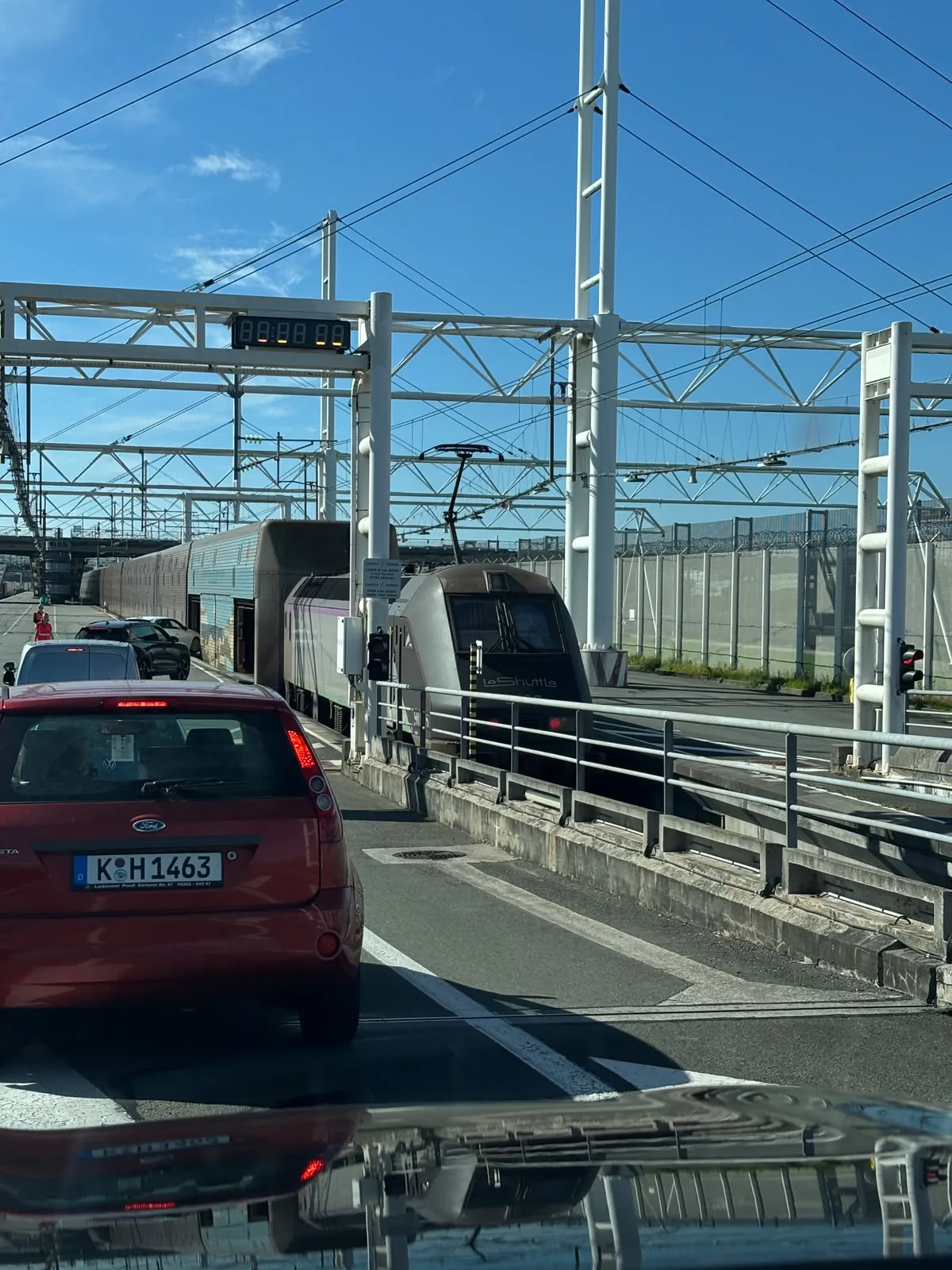LeShuttle boarding queue at Calais with illuminated board and locomotive