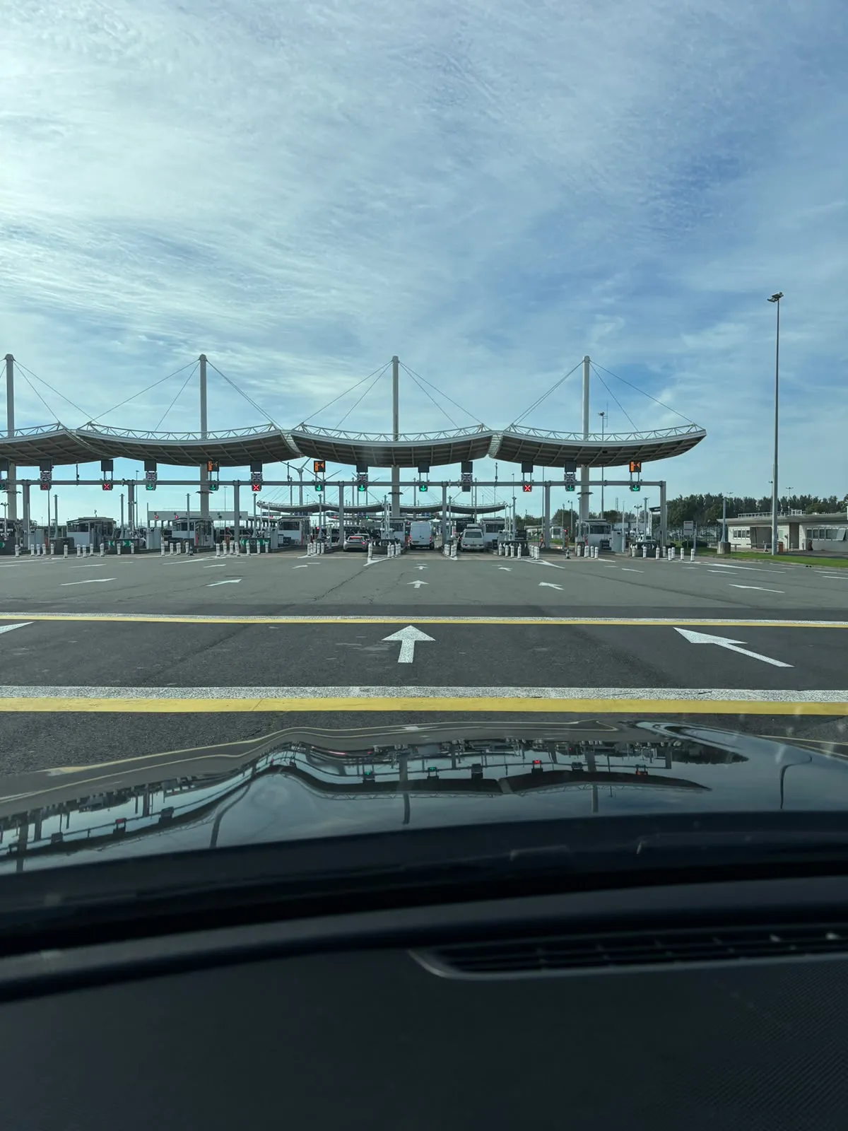 Eurotunnel check-in lanes at the Calais terminal seen through the windscreen of the chauffeur car