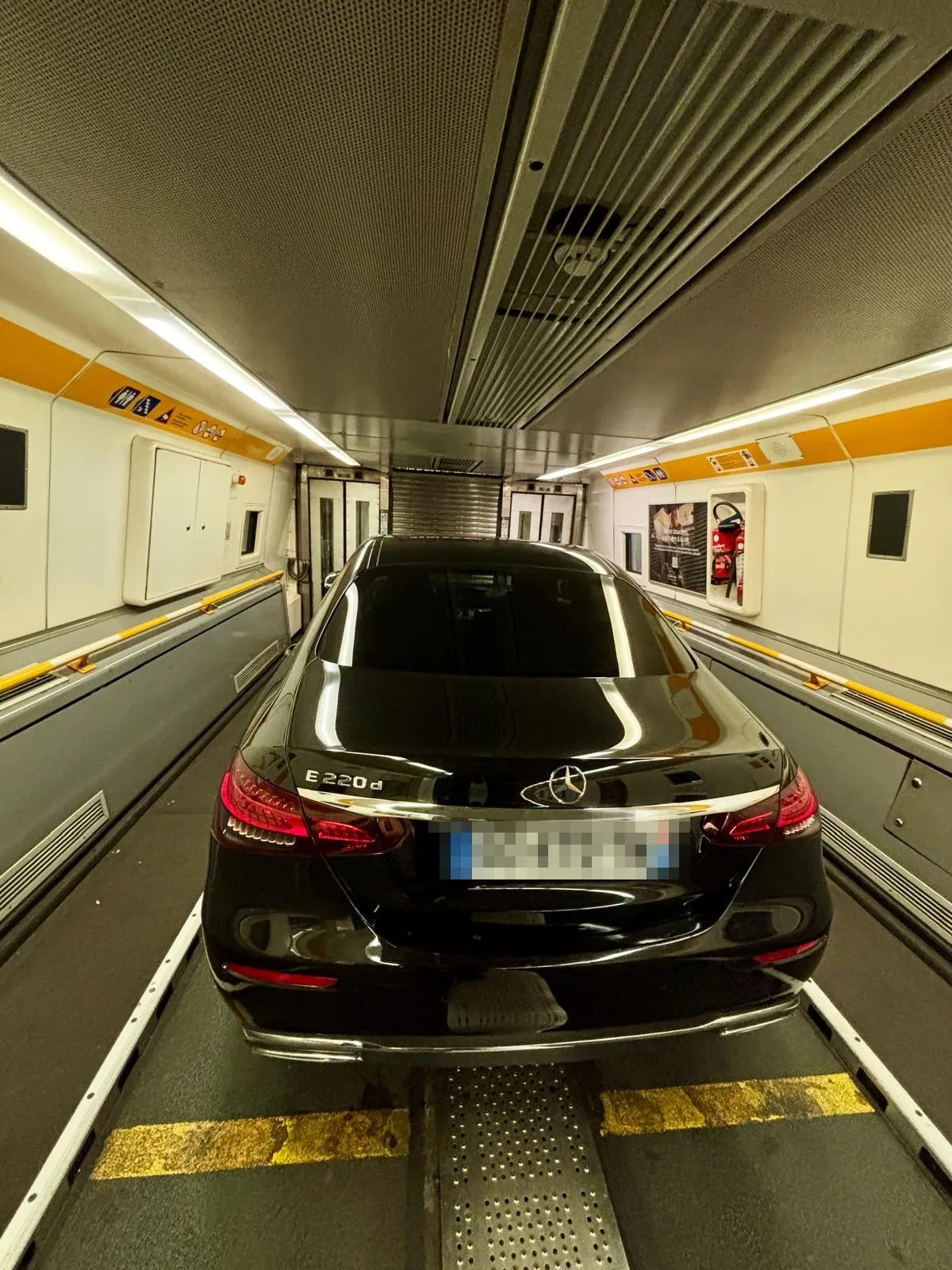 Chauffeur-driven Mercedes E-Class parked inside the LeShuttle carriage at Calais