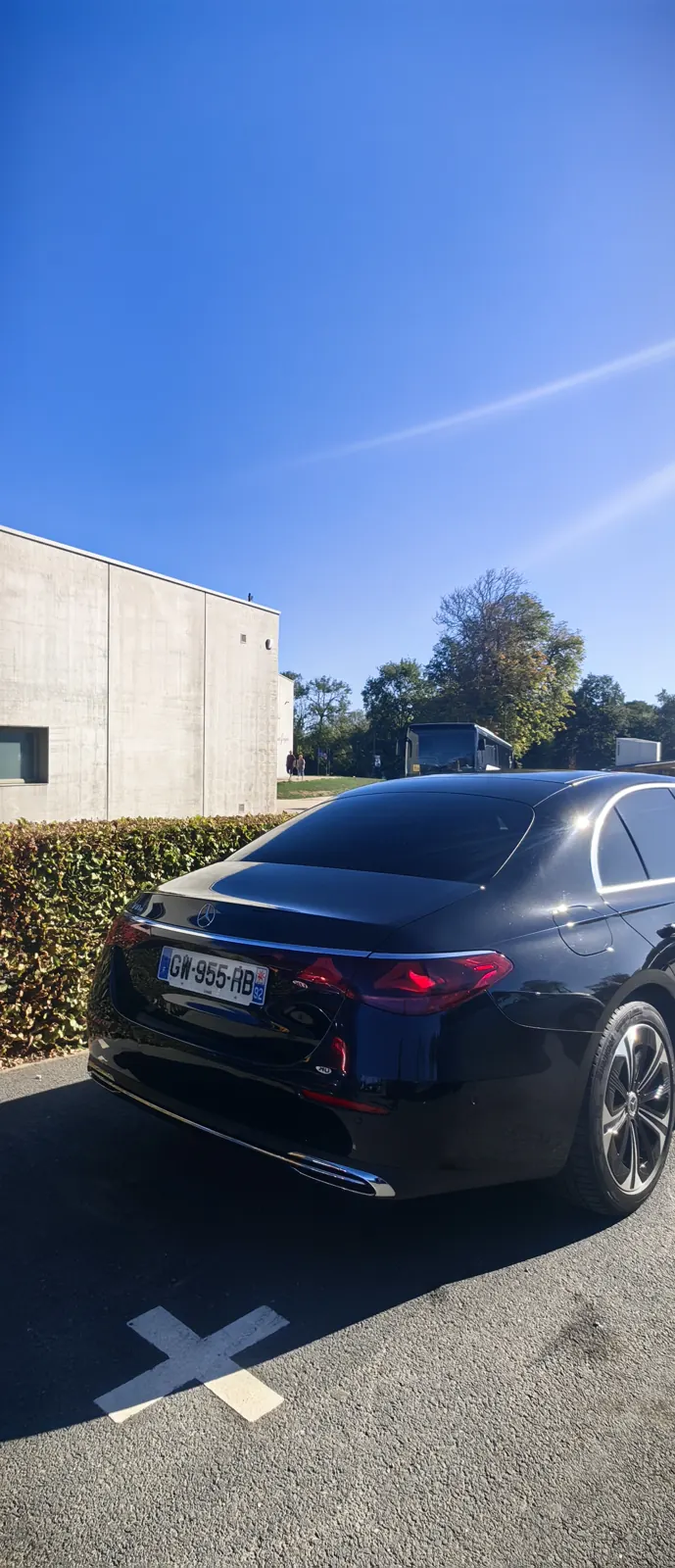 Rear view of our chauffeur-driven Mercedes E-Class parked at the Overlord Museum, Colleville-sur-Mer