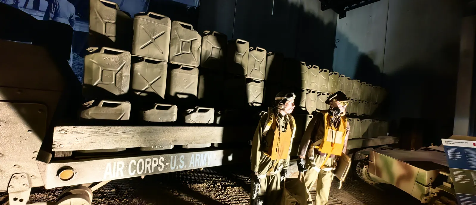 Two American airmen in flight gear beside the Air Corps U.S. Army trailer at the Overlord Museum near the Normandy American Cemetery